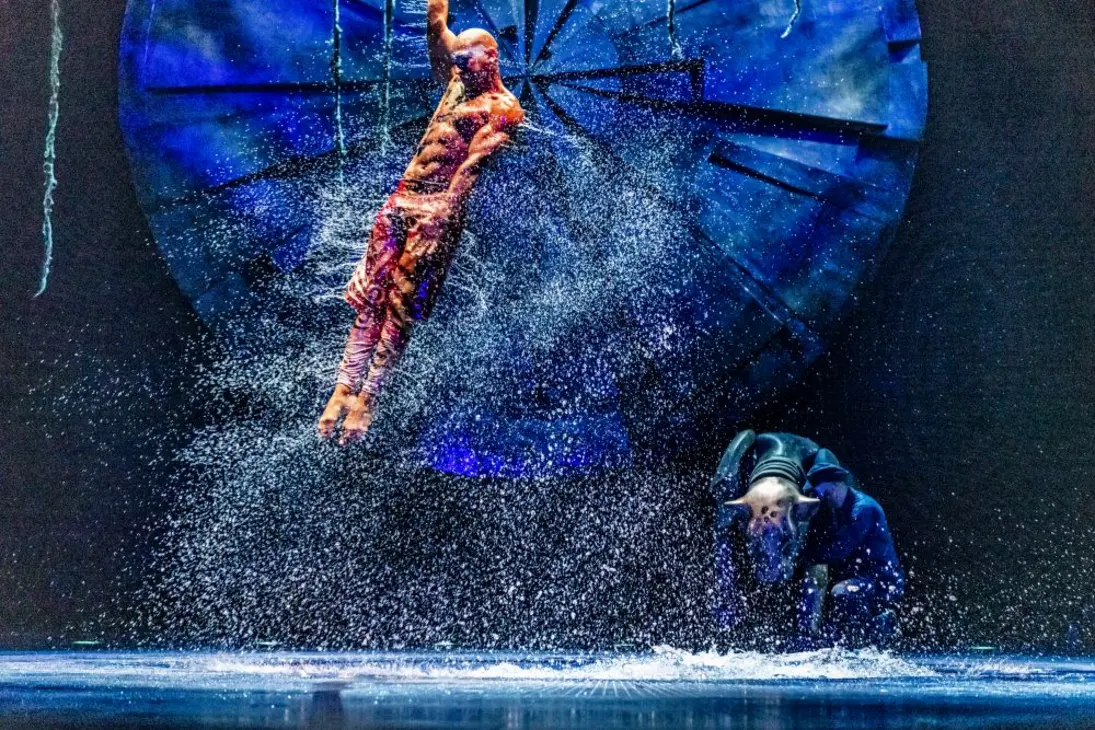 Acrobat performing with water on stage