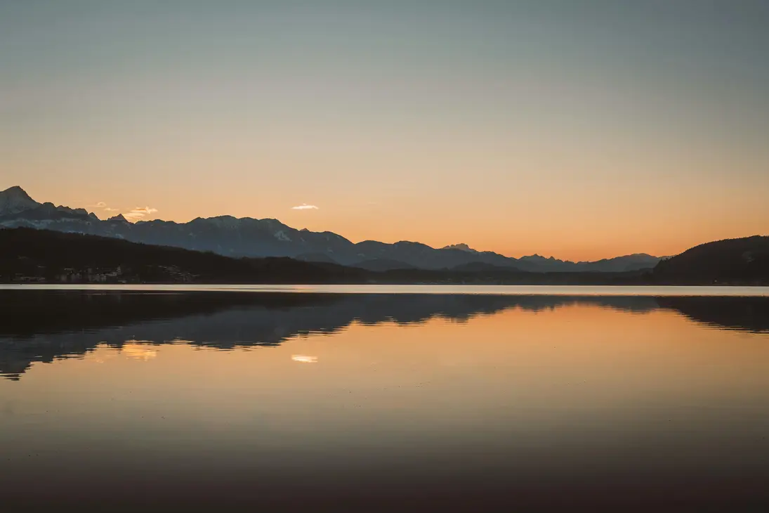 Mountain lake glowing in sunset light